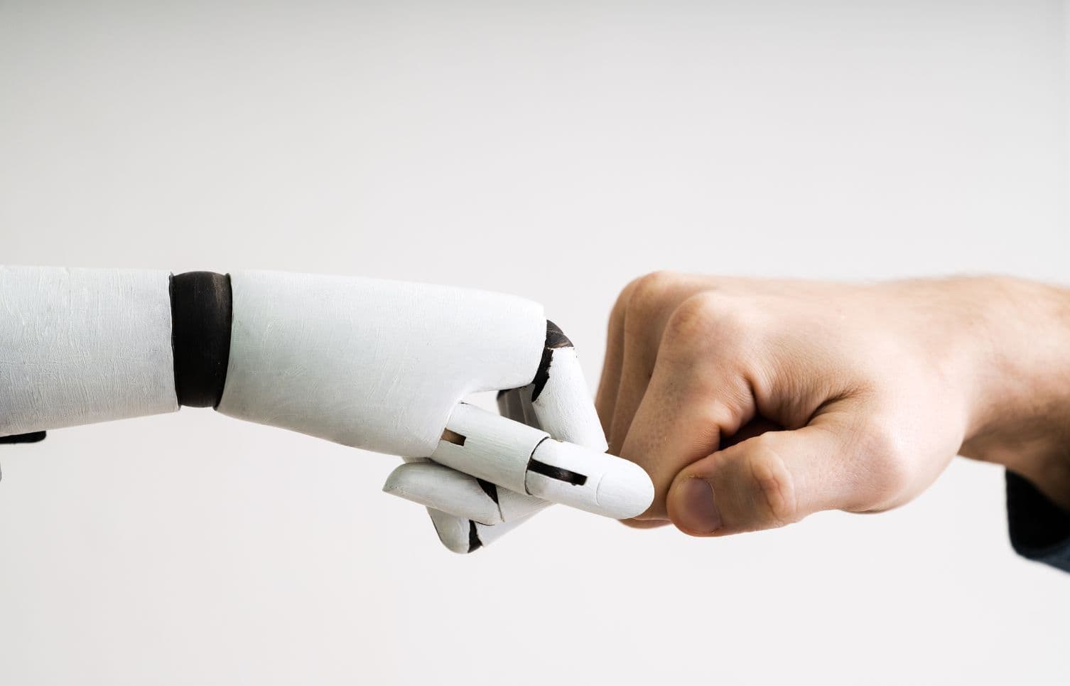 Digital interface showing a human hand typing into an AI system, representing prompt engineering and AI interaction